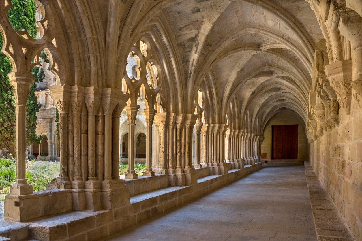 A long hallway with many pillars and arches.